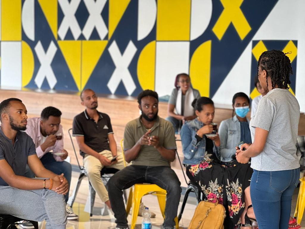 ALX learner speaking in front of her peers at a community event at the Addis Capstone Hub in Ethiopia