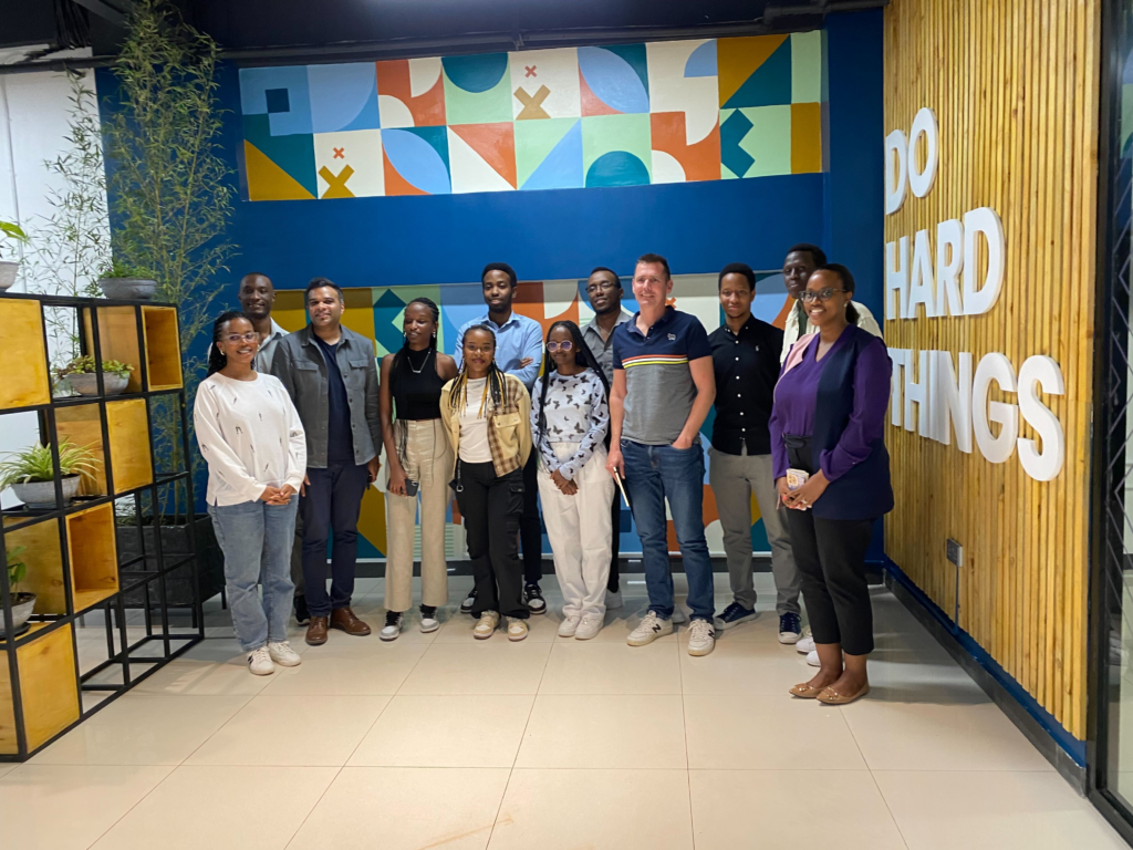 ALX learners and fellows pose for a picture with special guests at the Kigali Hub