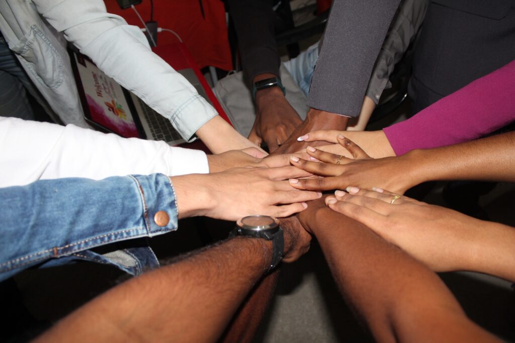 A photo of peoples' hands together as a sign of camaraderie. 